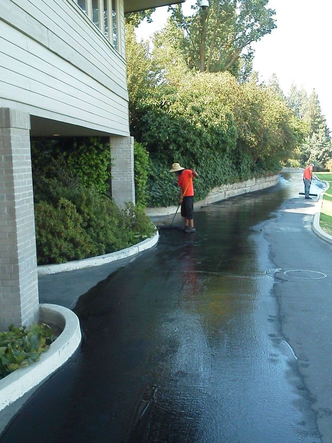 Sealcoat going down along a commercial drive lane.