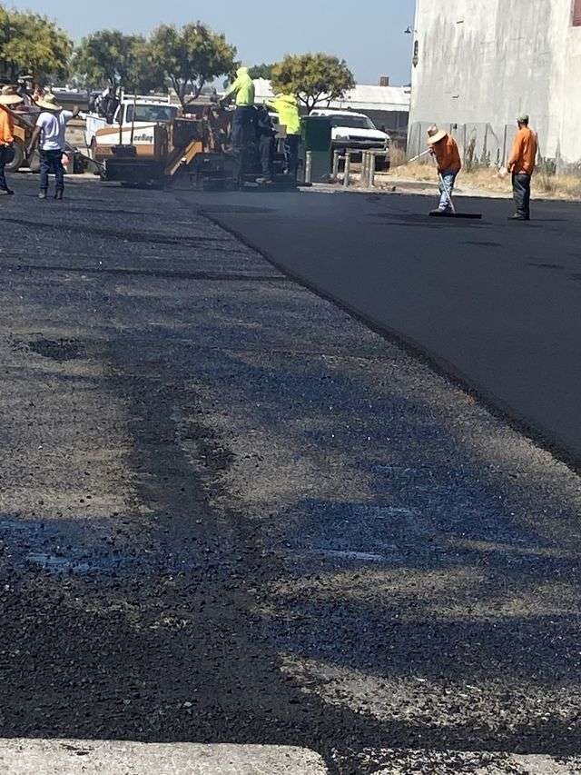 Paving crew working a fresh mat.